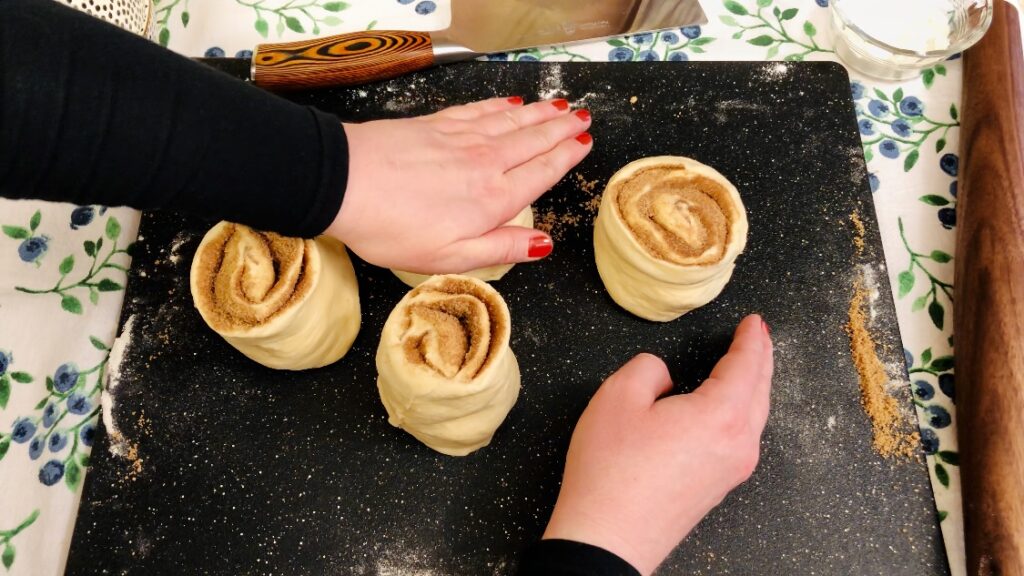 Pressing Down Cinnamon Rolls Before Baking